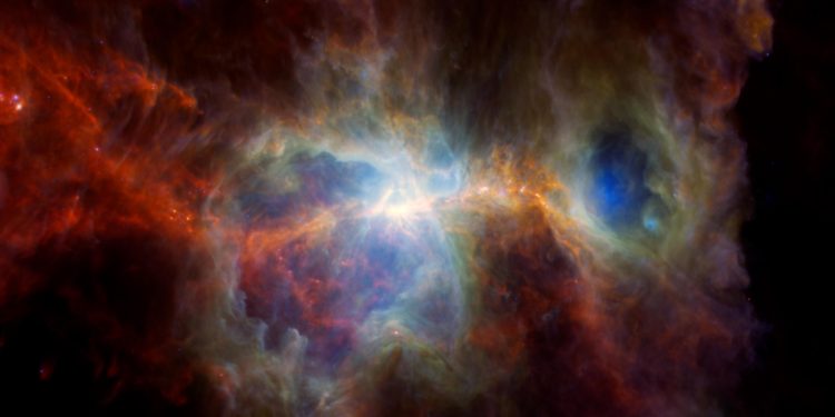 Immagine a infrarossi della Nebulosa di Orione, Si può notare molta polvere ma nessuna stella. Grazie all'infrarosso è possibile vedere i punti caldi in cui si stanno formando nuove stelle. Le cavità presenti nella nebulosa sono state create da stelle massicce e luminose. Credits: ESA/NASA/JPL-Caltech