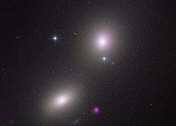 Immagine del telescopio spaziale Hubble di una coppia di galassie: NGC 6099 (in basso a sinistra) e NGC 6098 (in alto a destra). Il "blob" viola raffigura l'emissione di raggi X da un ammasso stellare compatto. I raggi X sono prodotti da un probabile buco nero di massa intermedia che fa a pezzi una stella. Credits: NASA, ESA, CXC, Yi-Chi Chang (National Tsing Hua University)